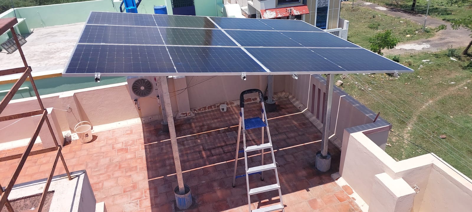 Solar panels installed as a shed on an open terrace, providing shade and renewable energy